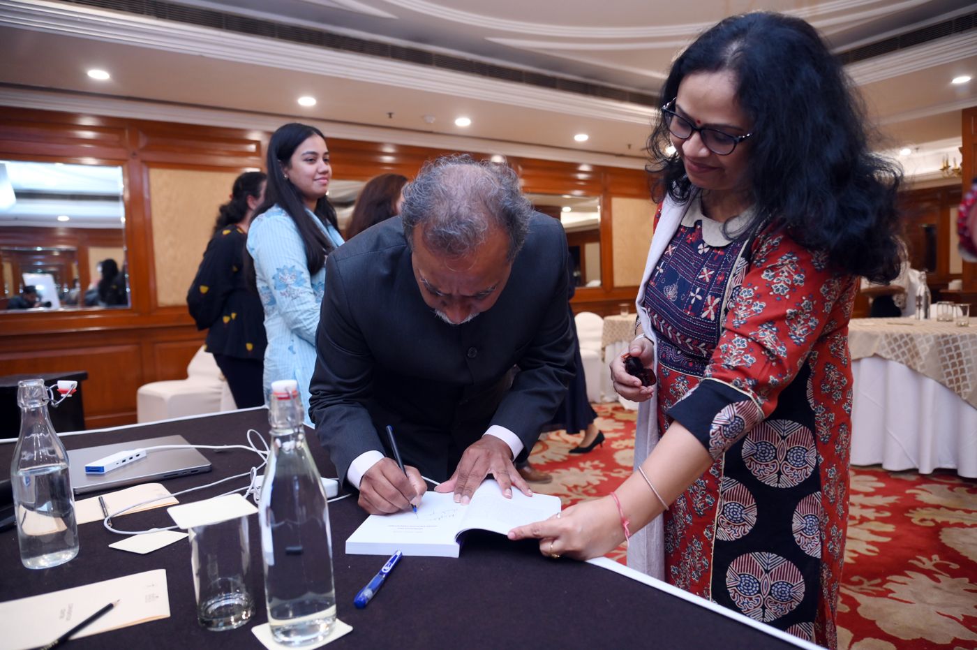 Dr. Louis signing a copy of Good Enough Parenting